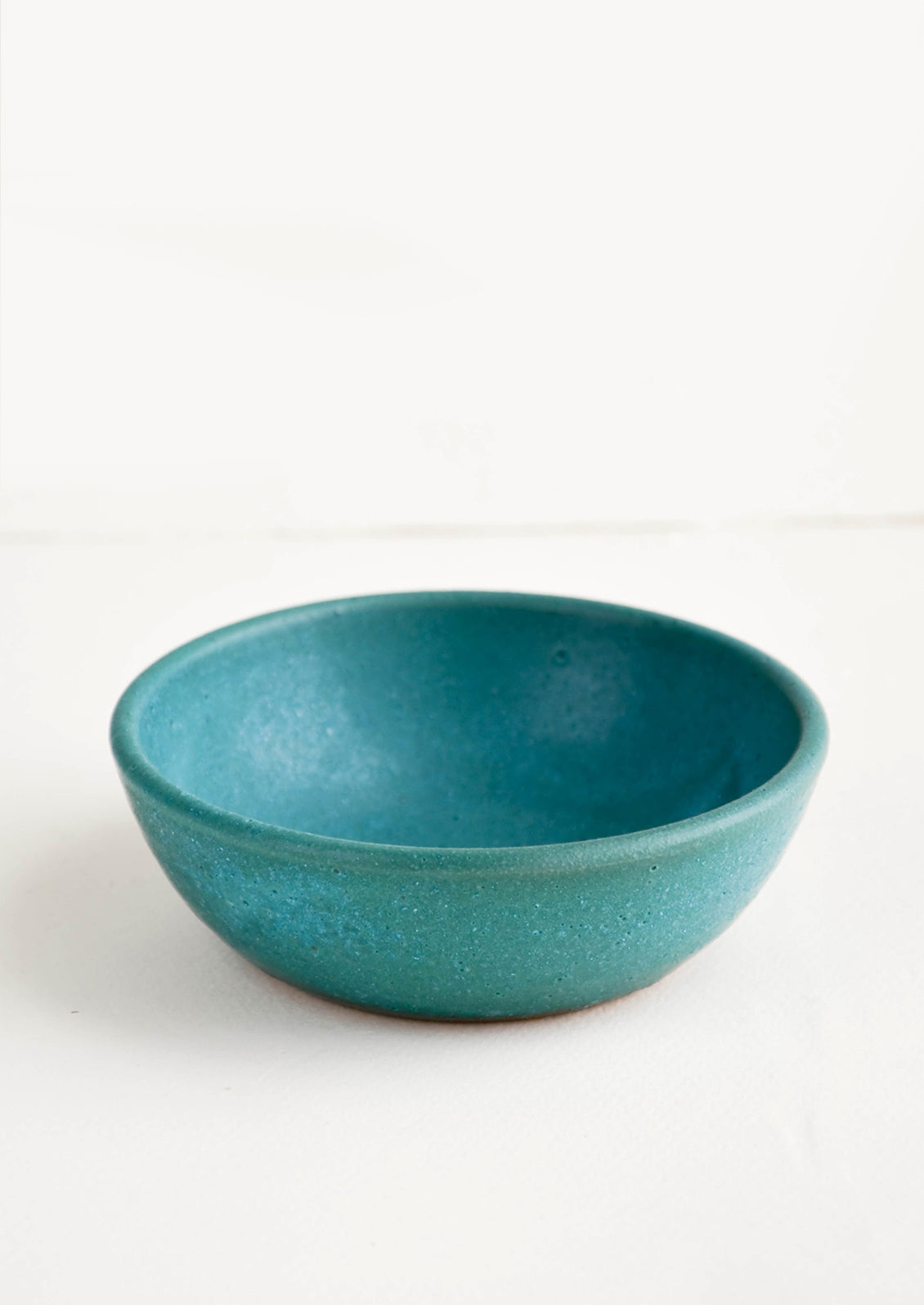  Small, handmade ceramic pinch bowl in rustic turquoise glaze