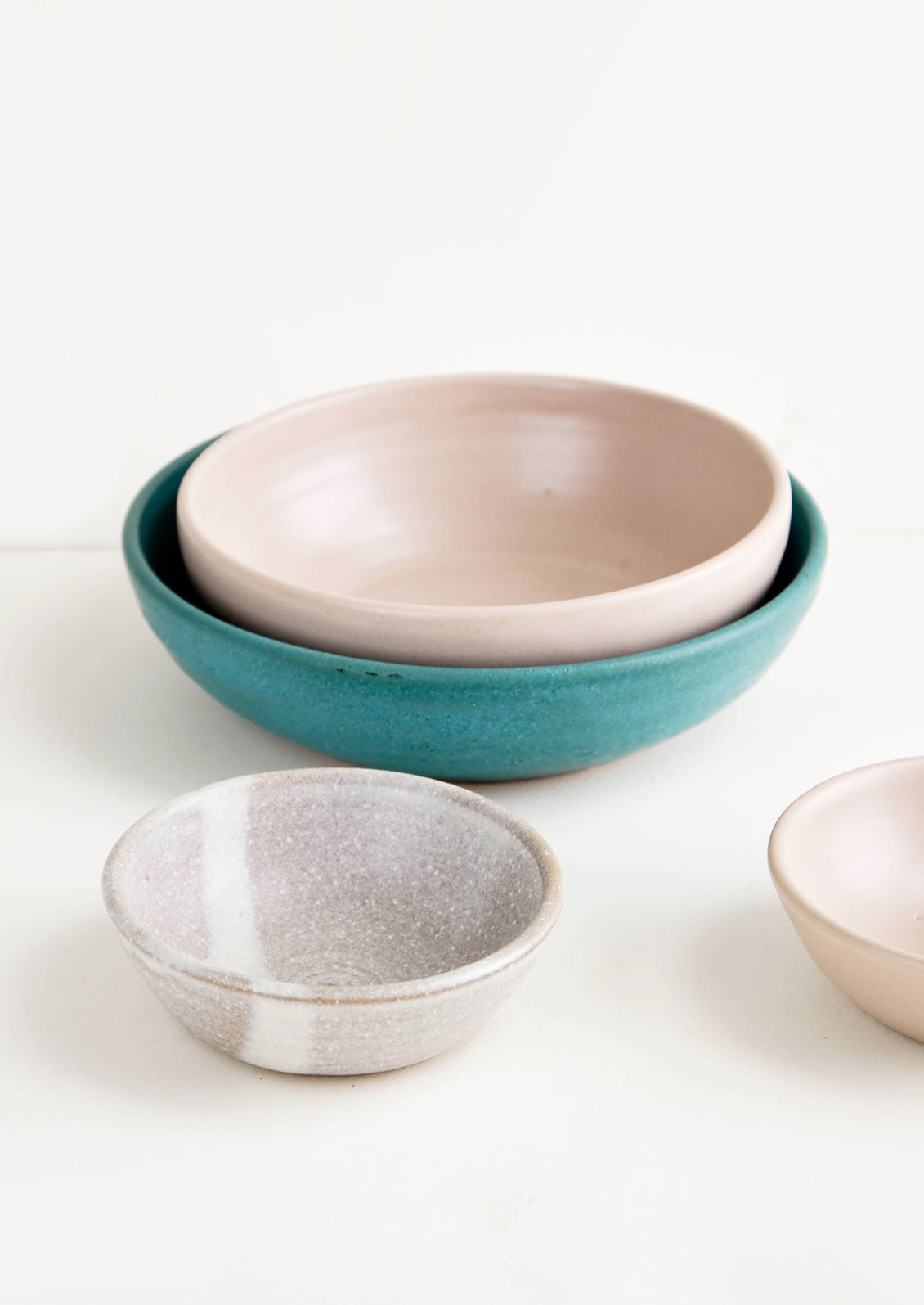 Grouping of handmade ceramic bowls in a mix of colors and sizes