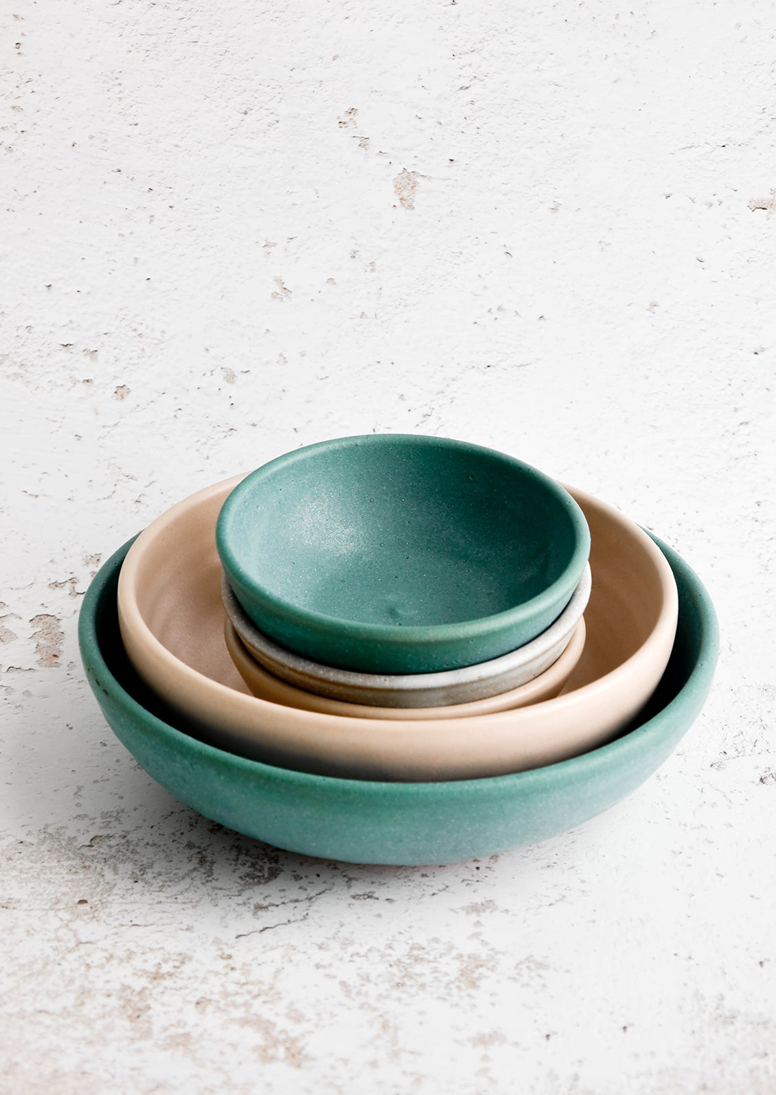 Stack of handmade ceramic bowls in nesting sizes