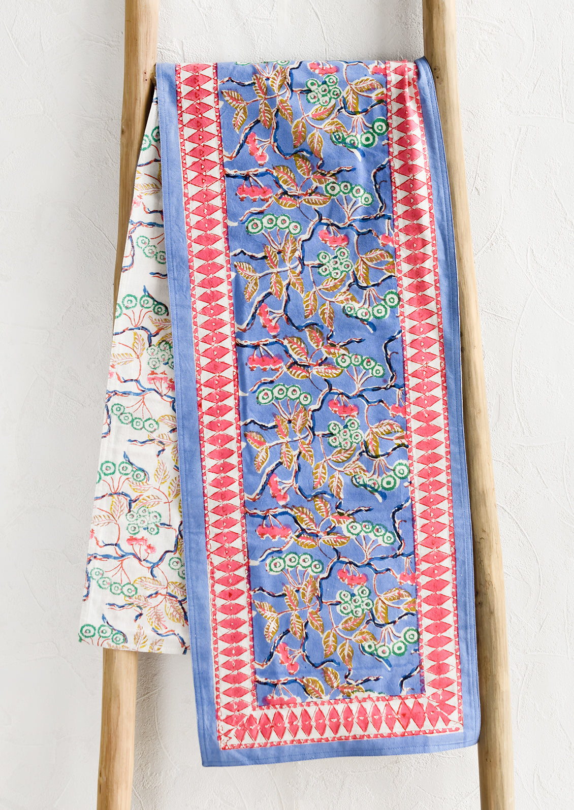 A block printed table runner in blue and pink floral.
