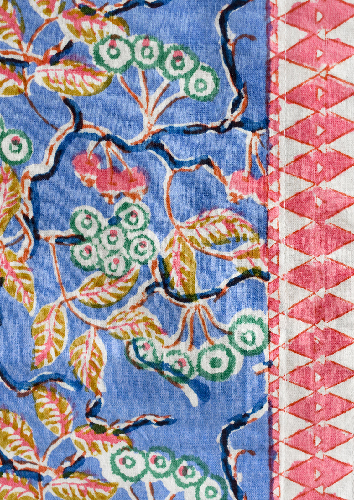 A block printed table runner in blue and pink floral.