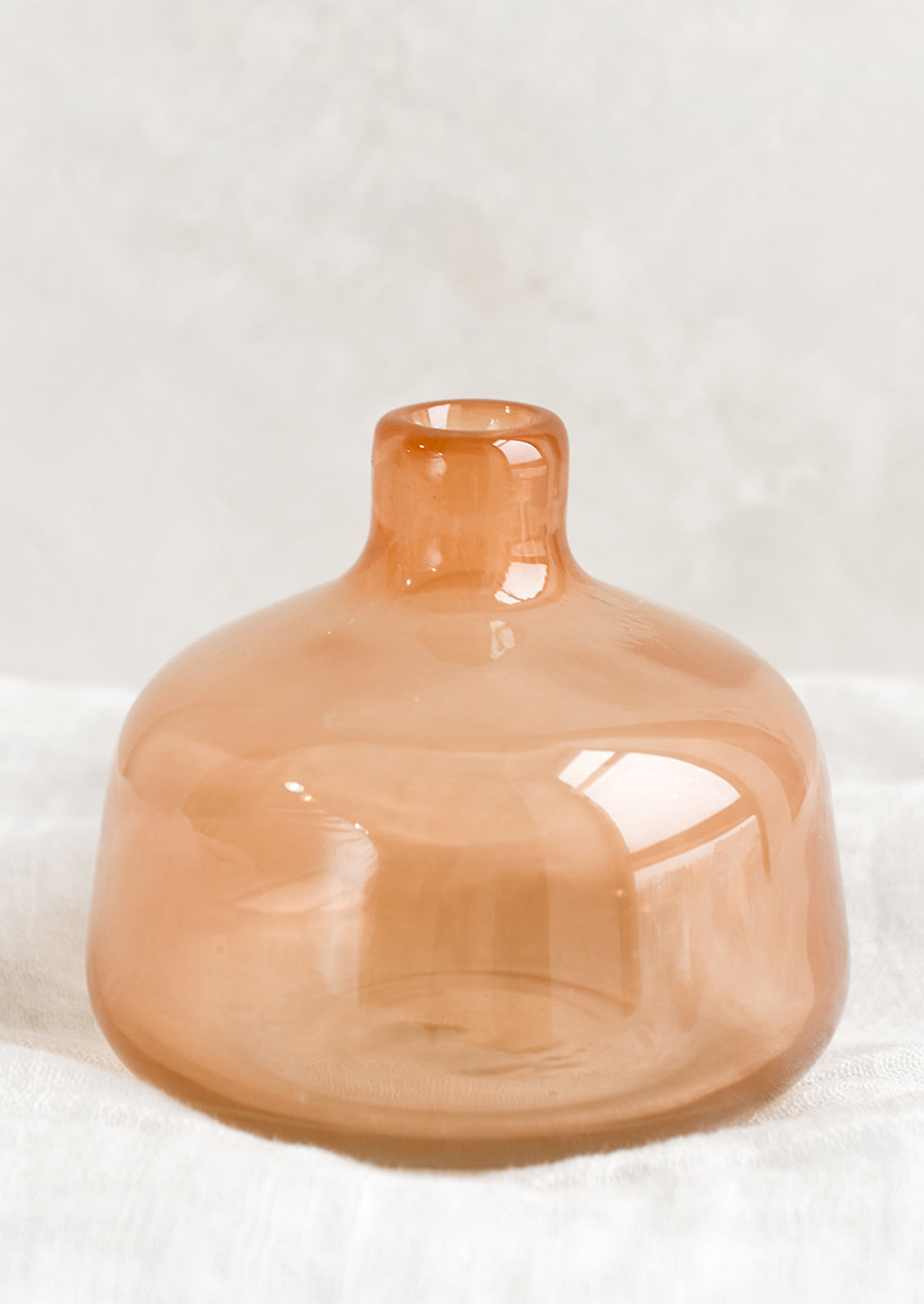 A peach glass bud vase.