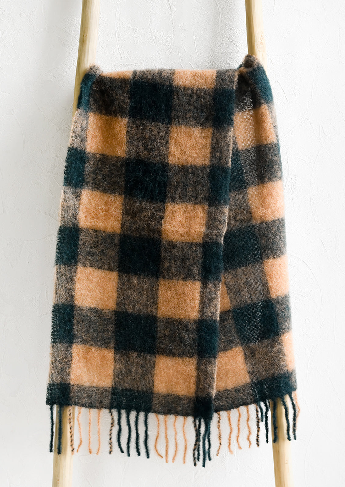 A cozy scarf in green and brown check print.