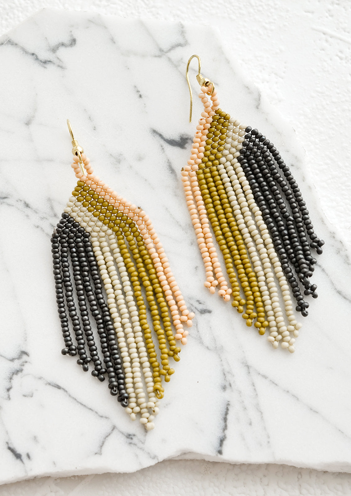 A pair of beaded earrings with colorblock stripe pattern.
