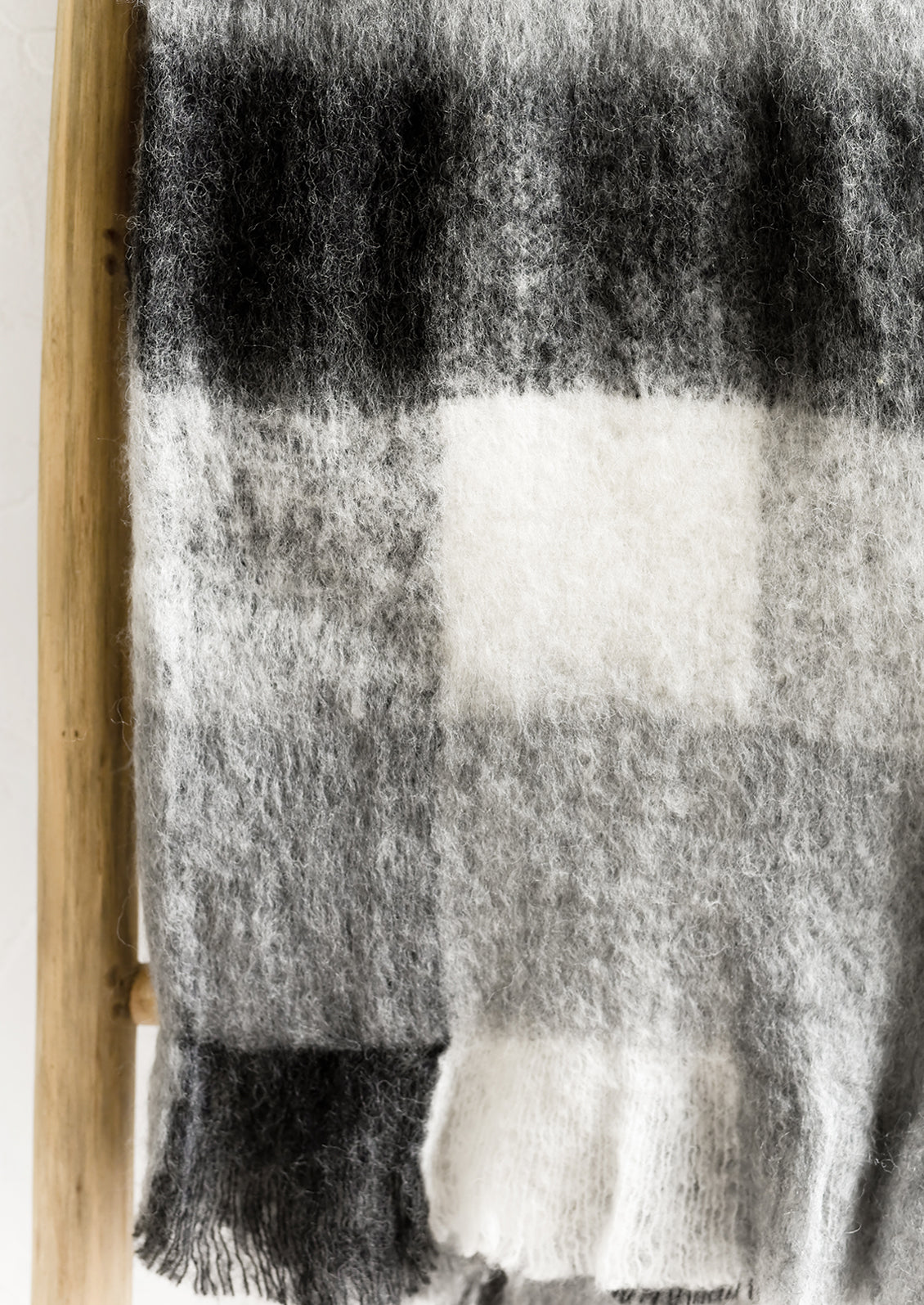 A gingham mohair throw blanket in black and white.