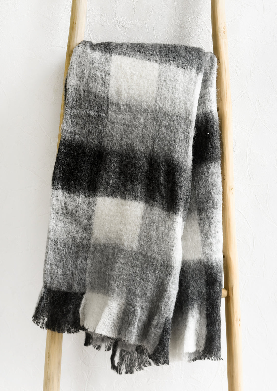 A gingham mohair throw blanket in black and white.