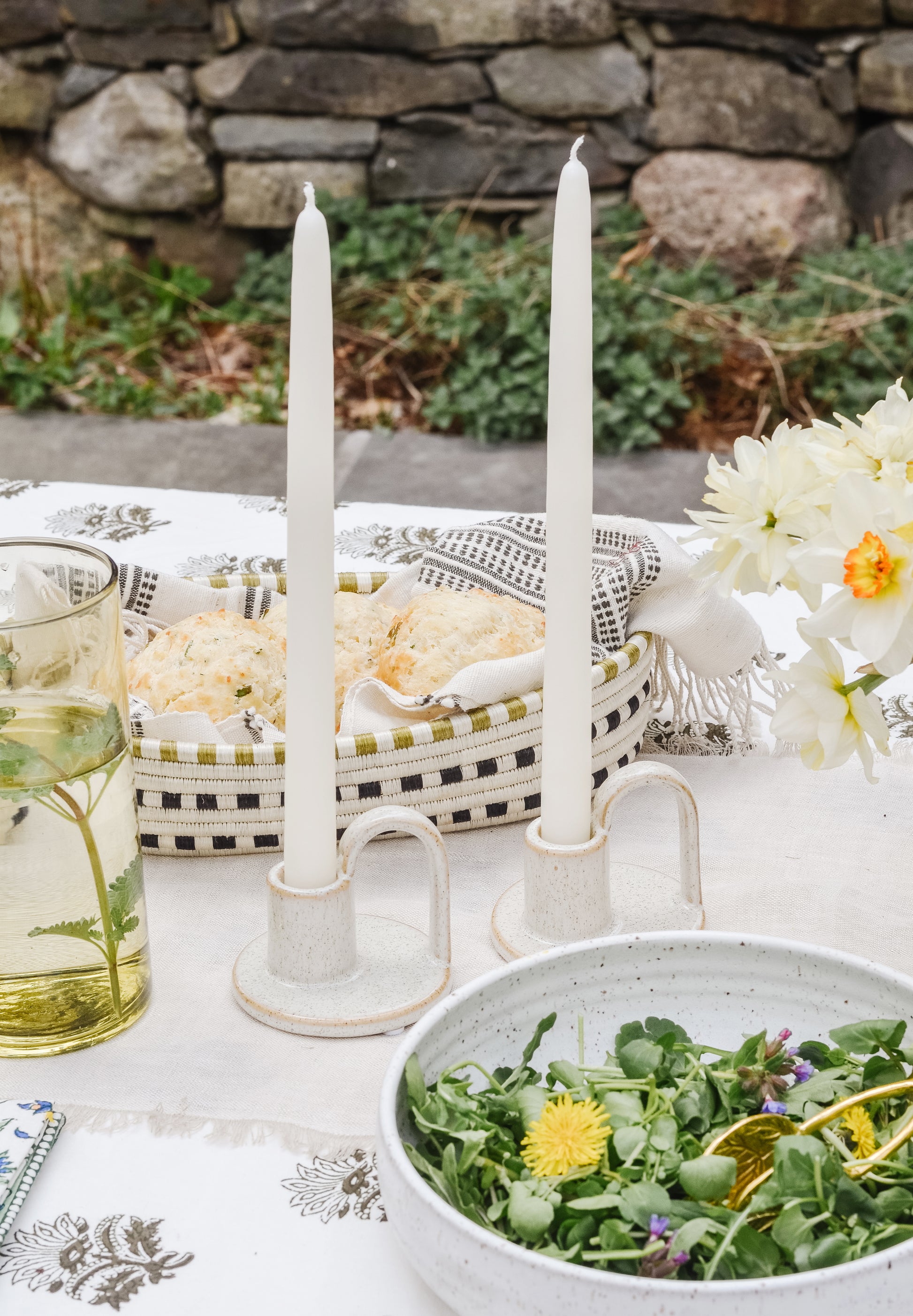 Taper candles on a tabletop scene.