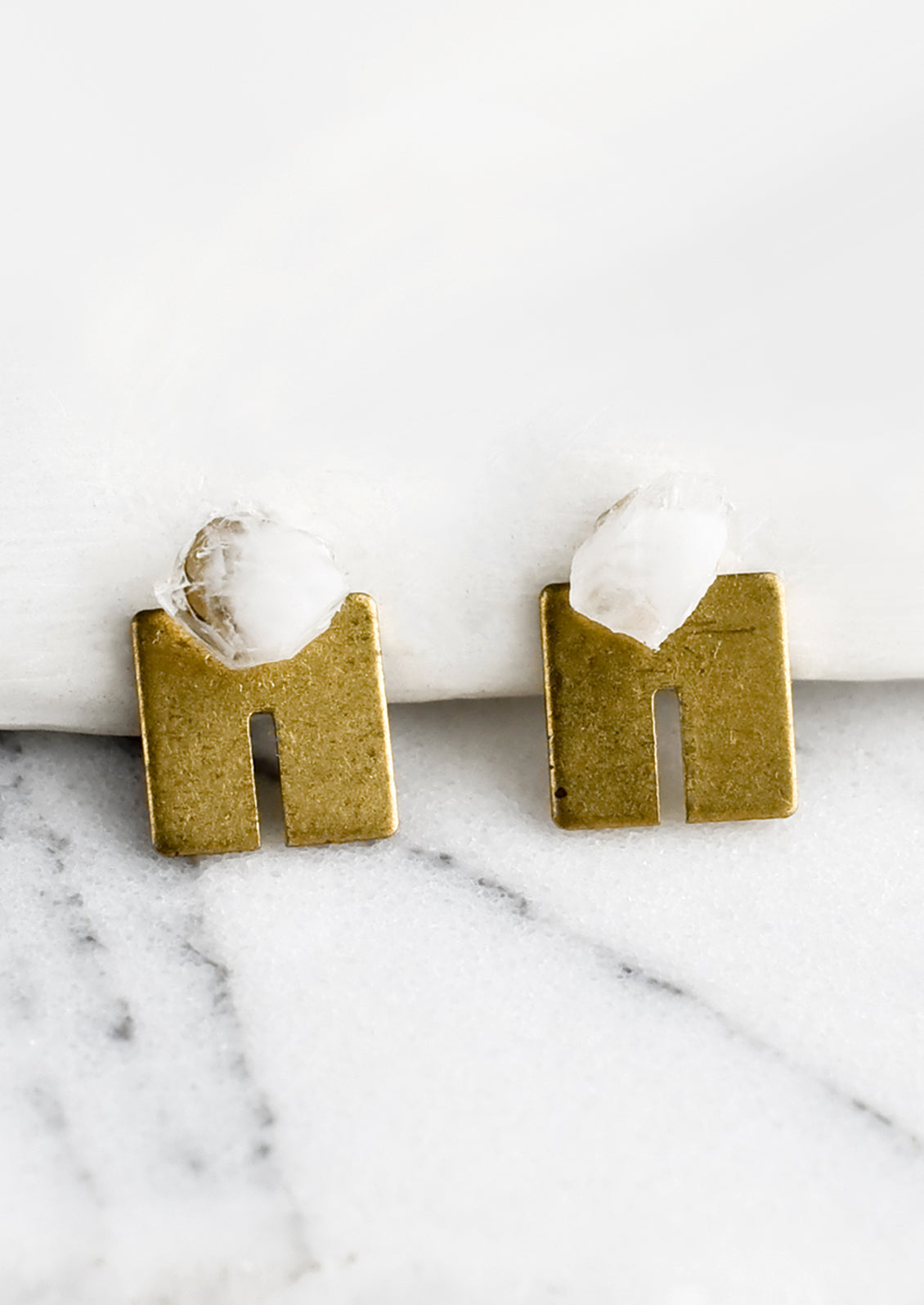 A pair of squared U shaped brass studs with raw quartz gemstone post.