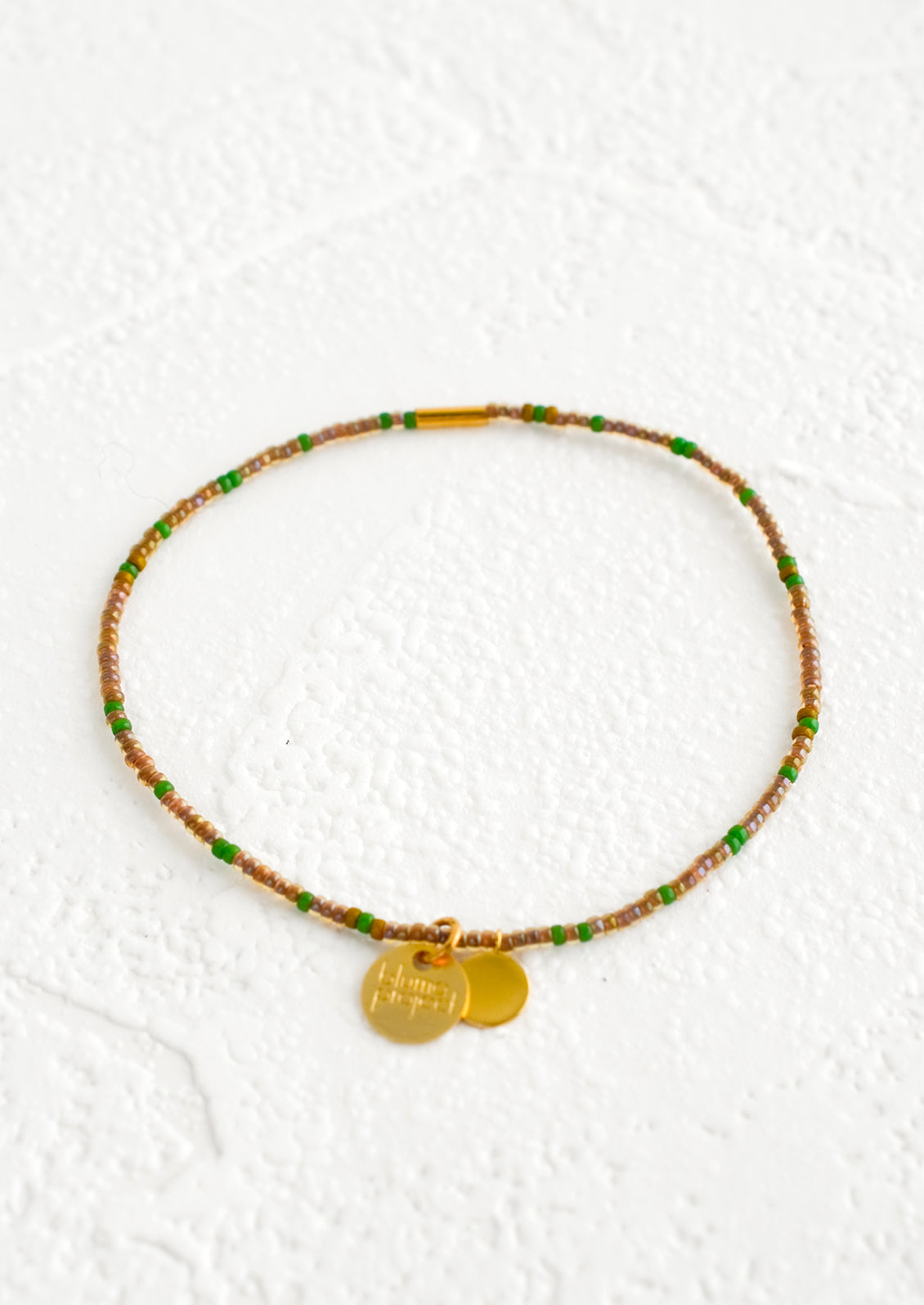 Seed bead bracelet in brown and green with brass accents