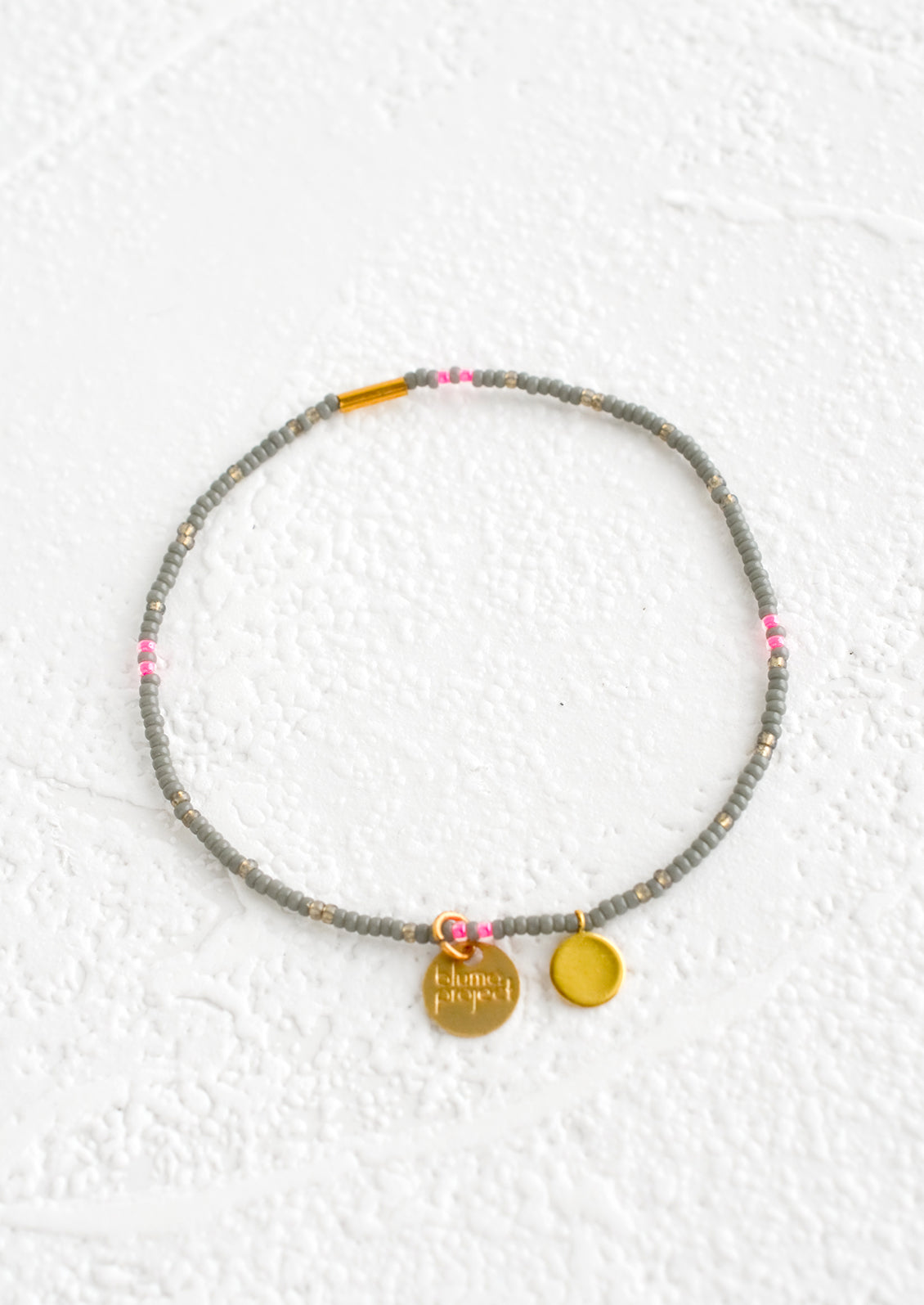 Seed bead bracelet in grey and neon pink with brass accents