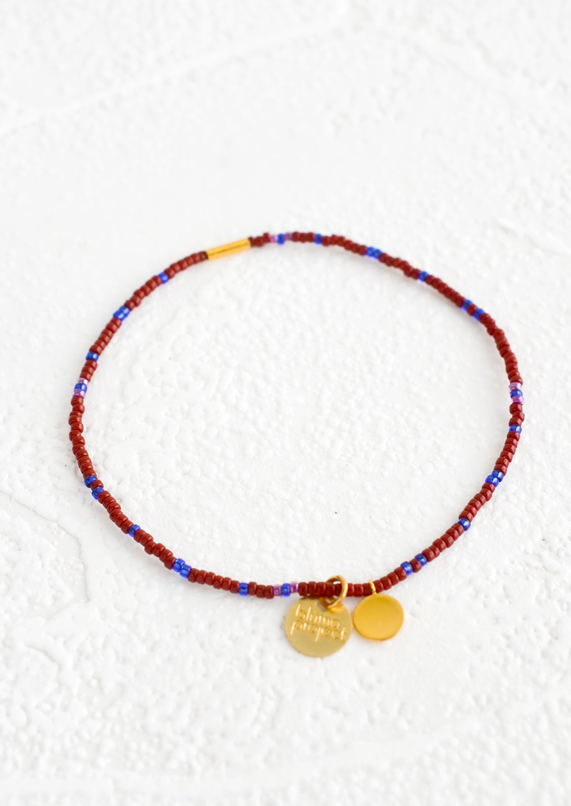 Seed bead bracelet in wine and blue with brass accents