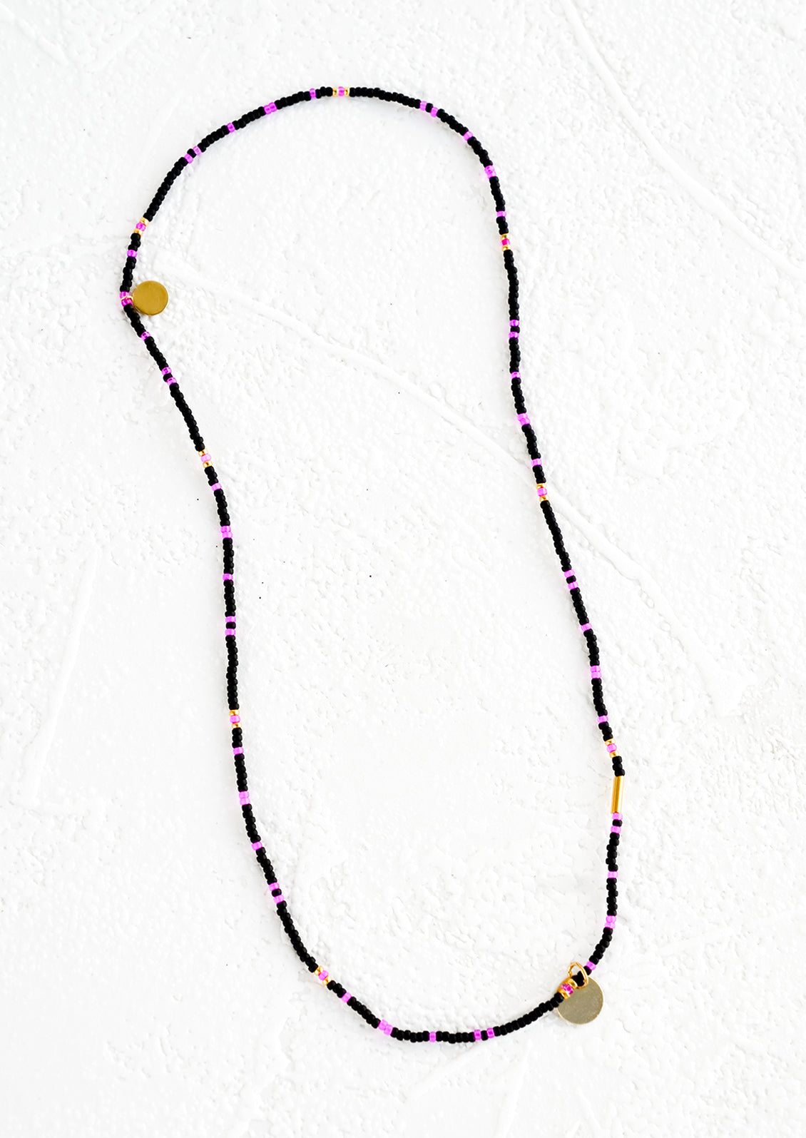 A seed bead choker necklace in black and neon pink beads.