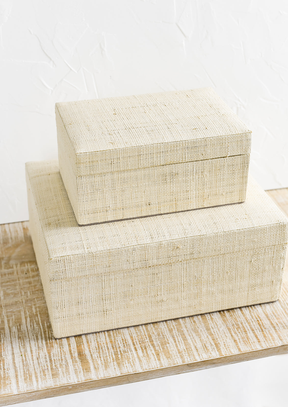 Small and large upholstered linen storage boxes.