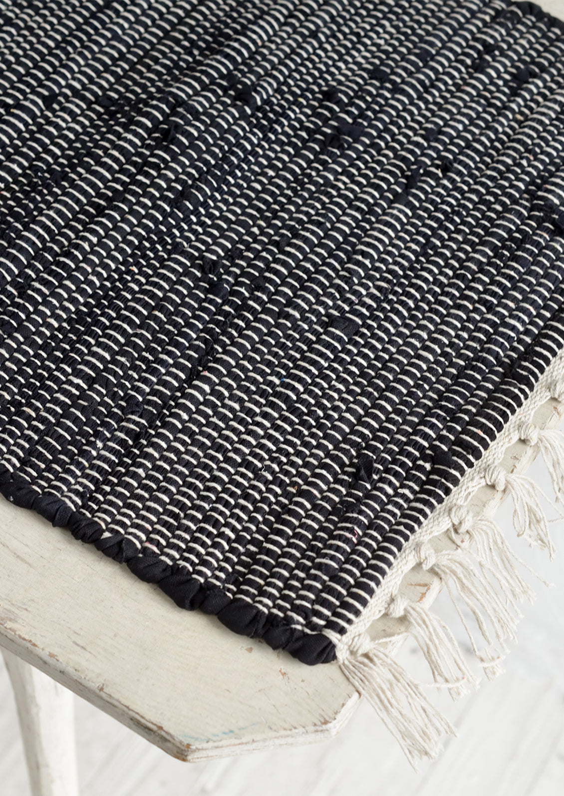 A black and white chindi weave table runner.