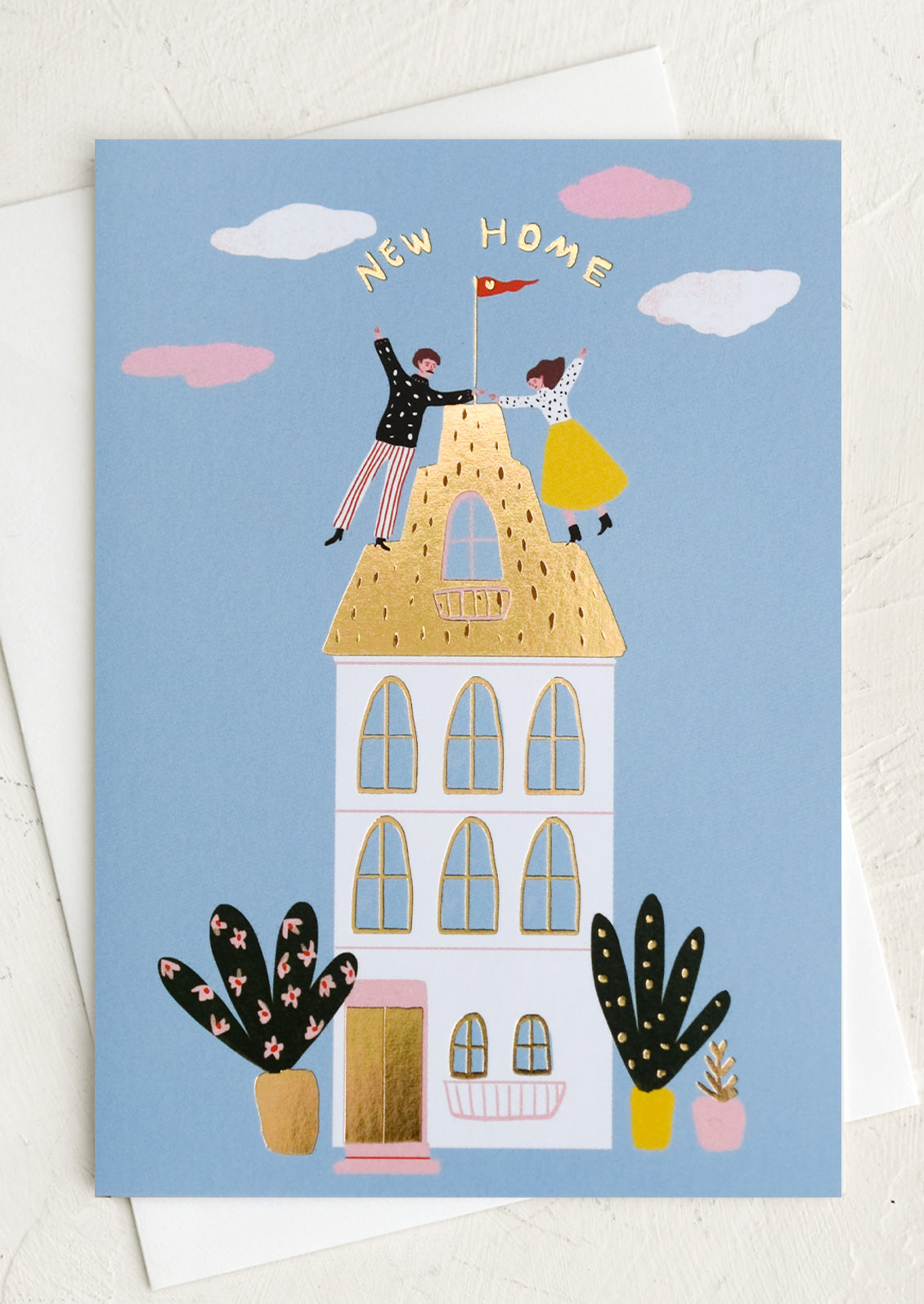 A card with illustration of man and woman on the roof of a tall house, text reads "New home".