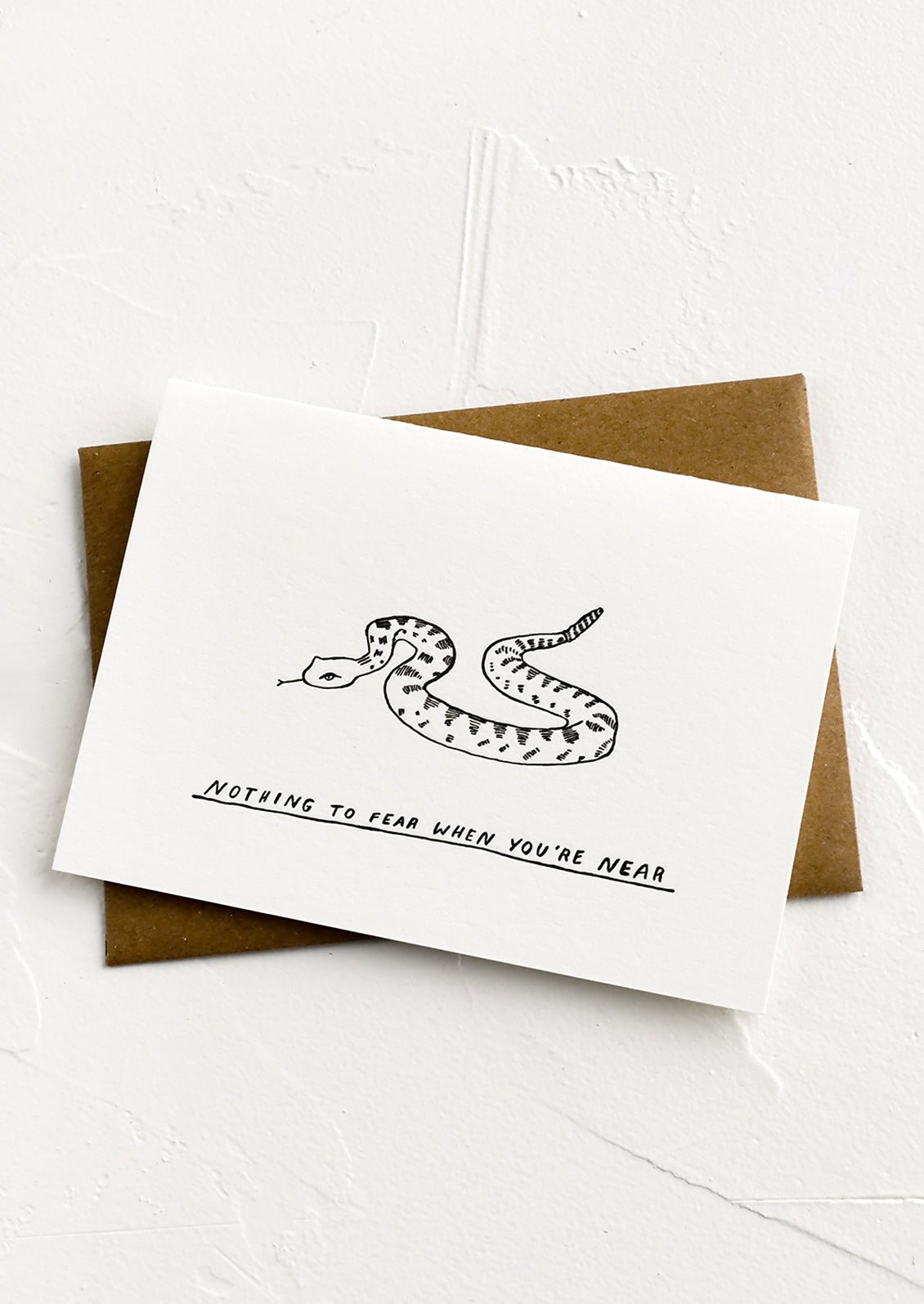 A greeting card with image of snake and text below reading "Nothing to fear when you're near".