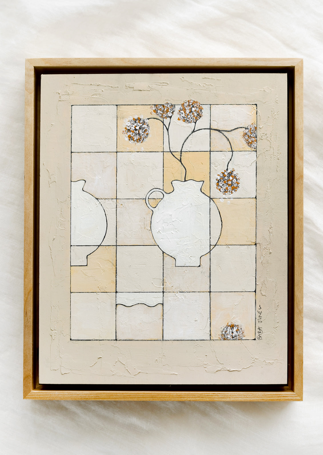 A framed still life painting of vase with flowers on checkered background.