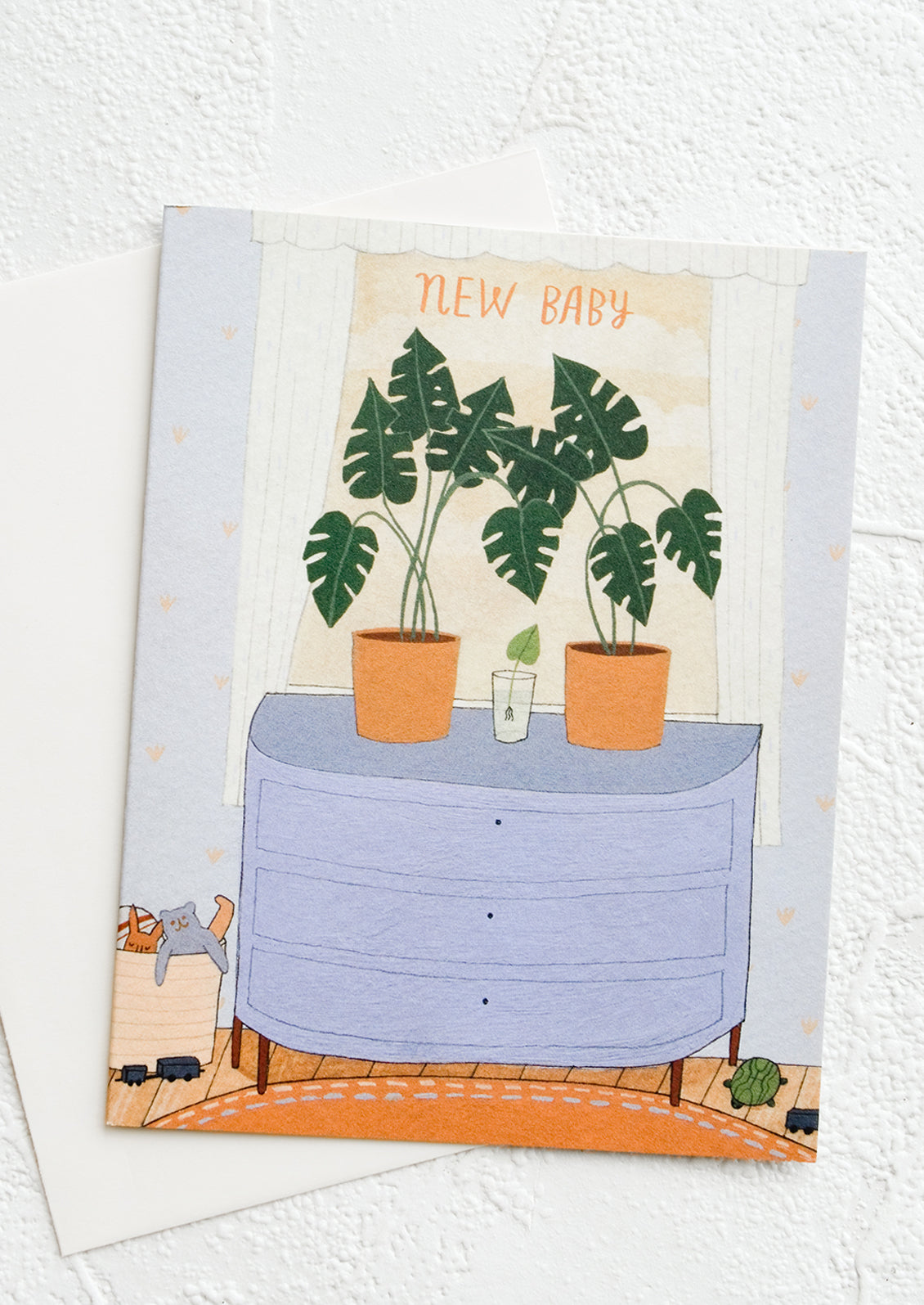 A greeting card with illustration of a sprouting plant in between two larger plants, inside a nursery.