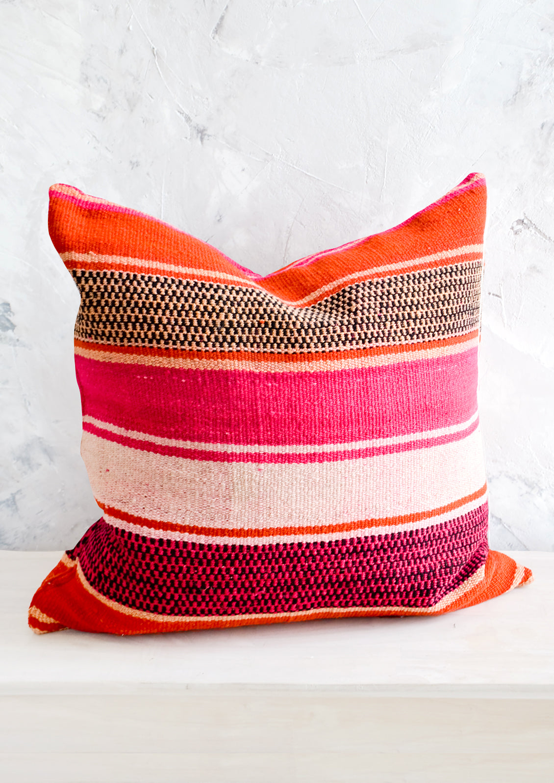 Throw pillow in orange, pink and peach striped vintage wool fabric