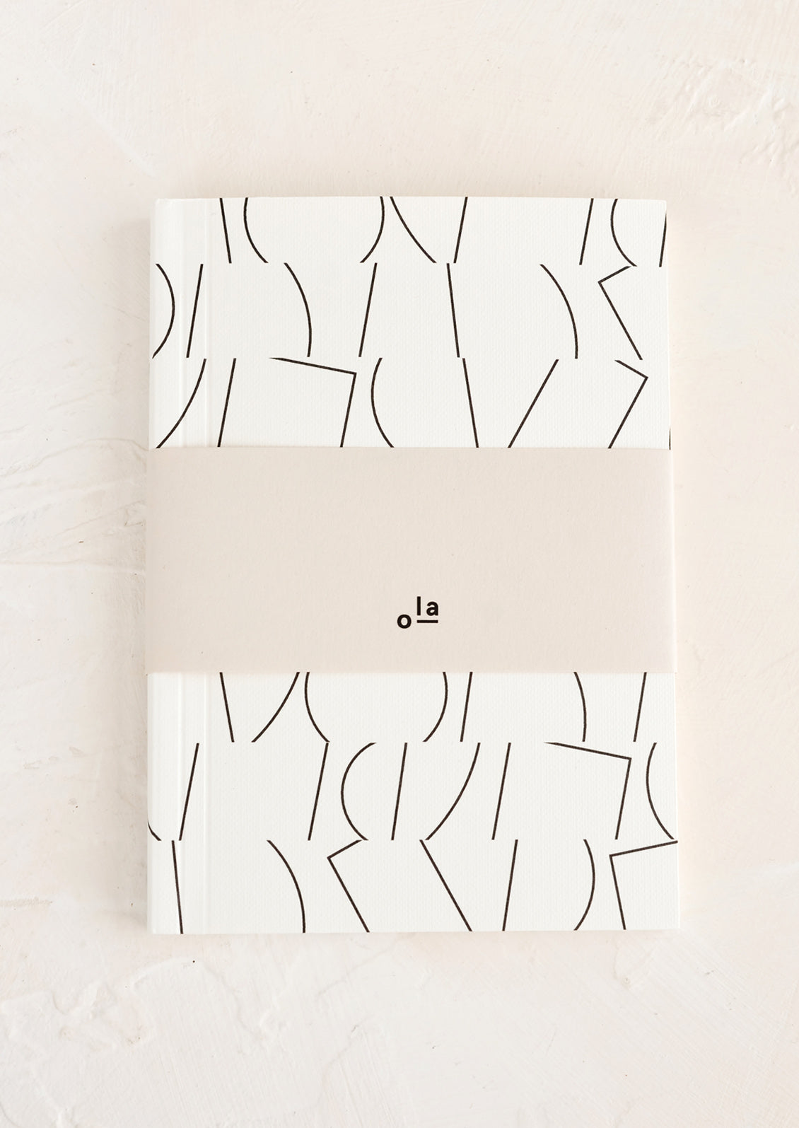 A small notebook with abstract print cover in black and white.