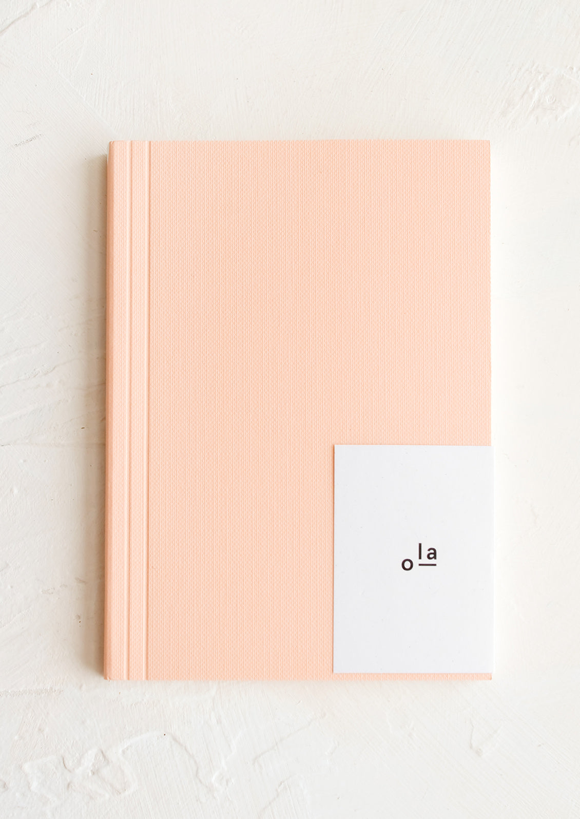 A small peach notebook.