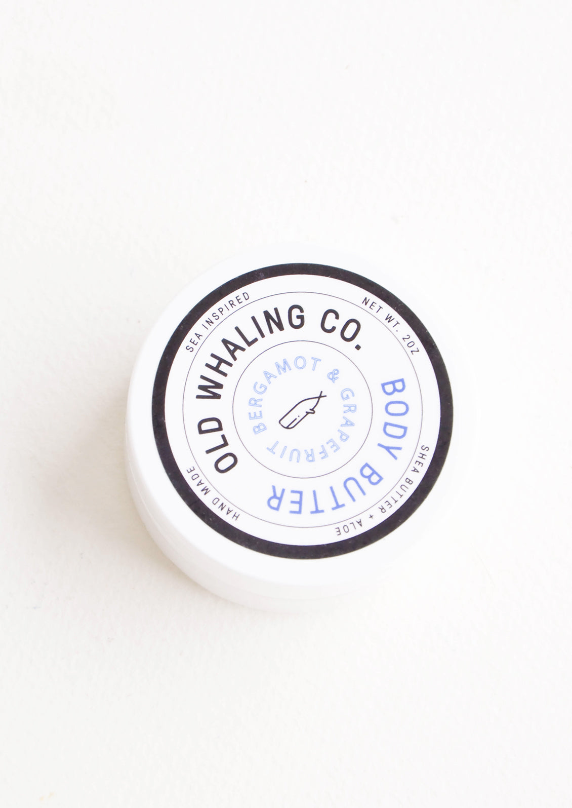 Round plastic jar of body/hand lotion in bergamot & grapefruit scent
