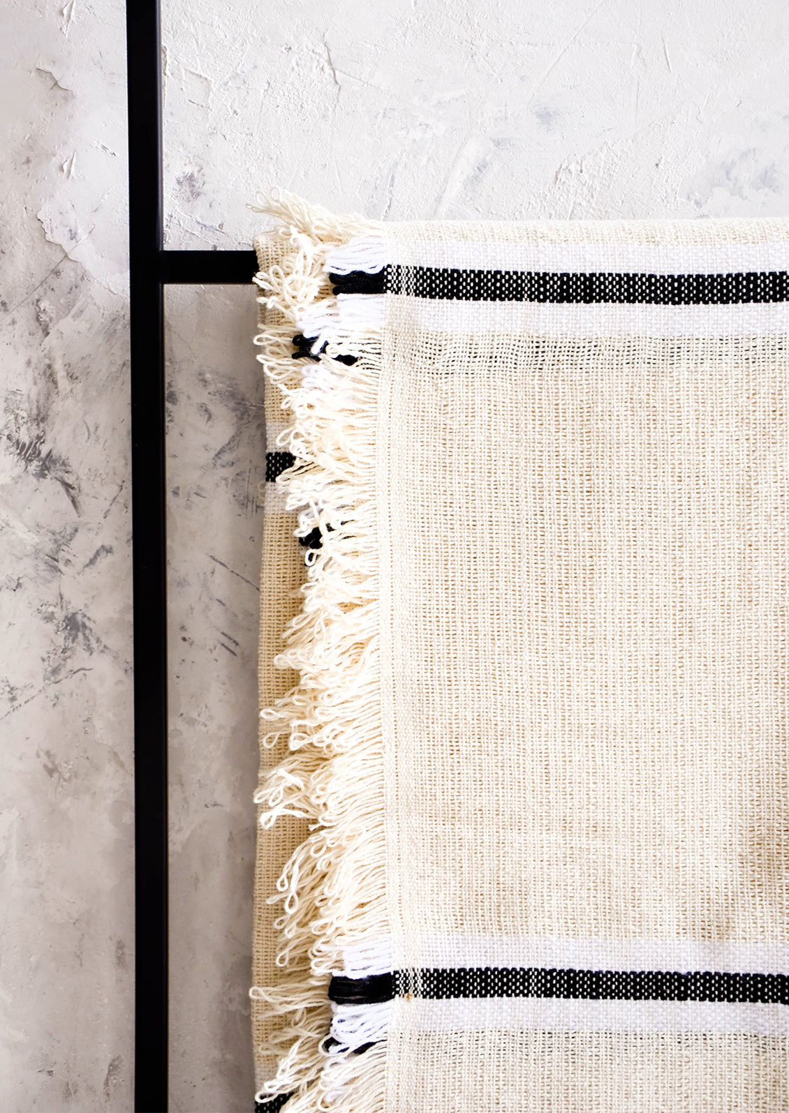 Looped, fringed edge trim on a raw cotton blanket