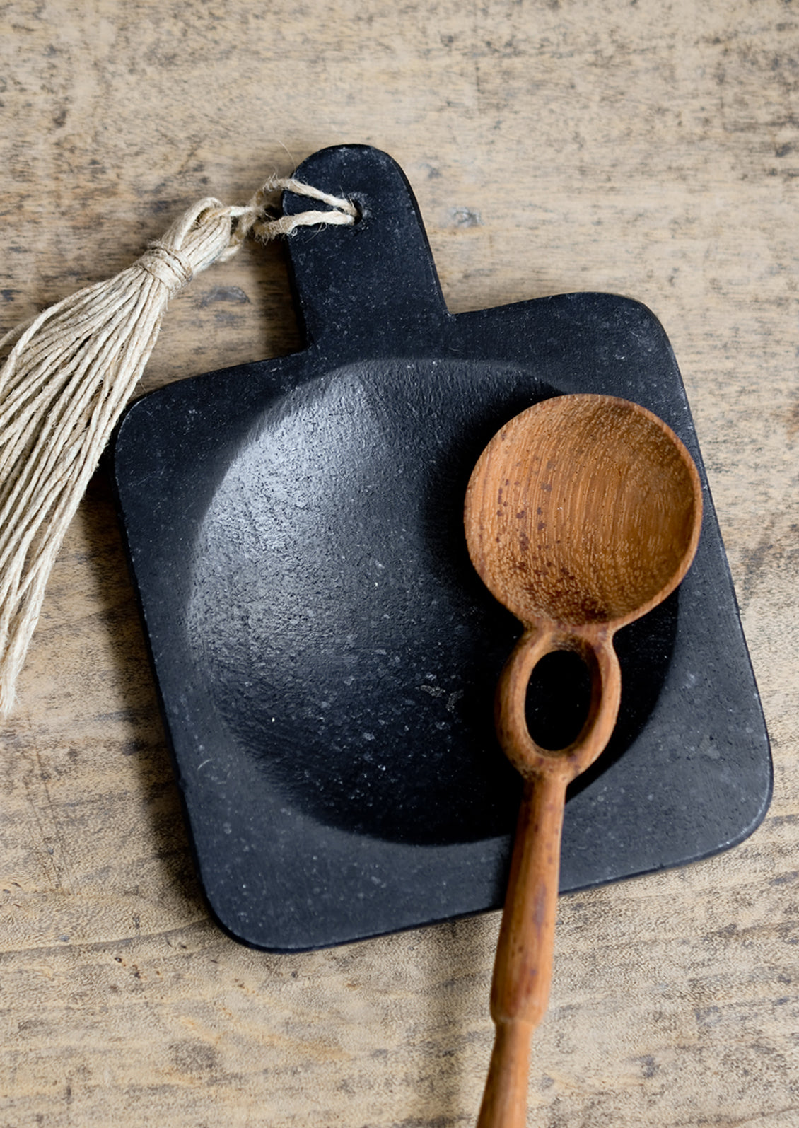 A paddle shaped marble spoon rest in black.