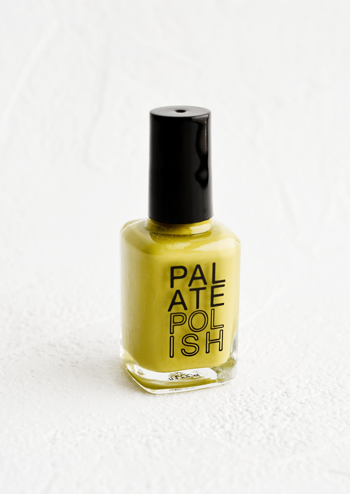 A bottle of nail polish in chartreuse.