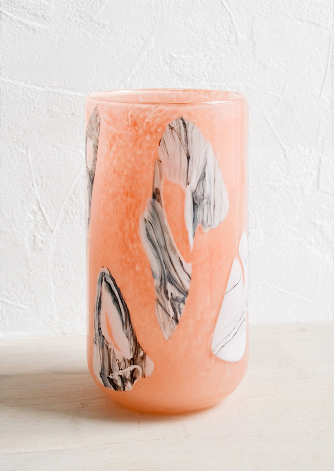Peach glass vase with white and grey inlay pattern.