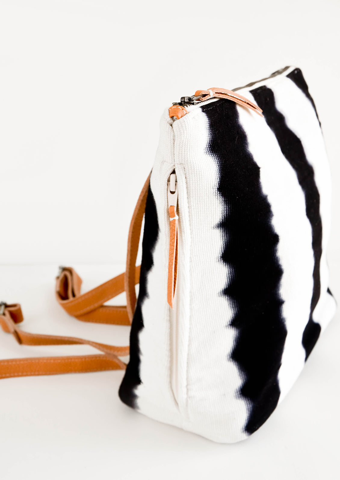 Fashion backpack made from tie dye cotton canvas, featuring concealed side zip pocket on exterior