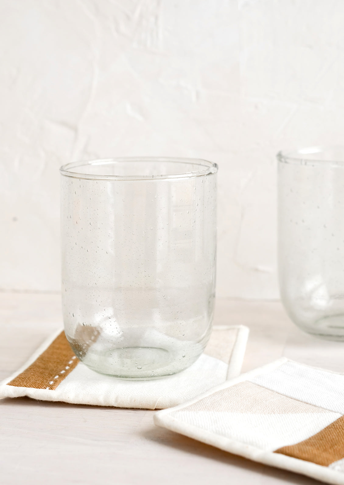 Glass cups on fabric coasters.