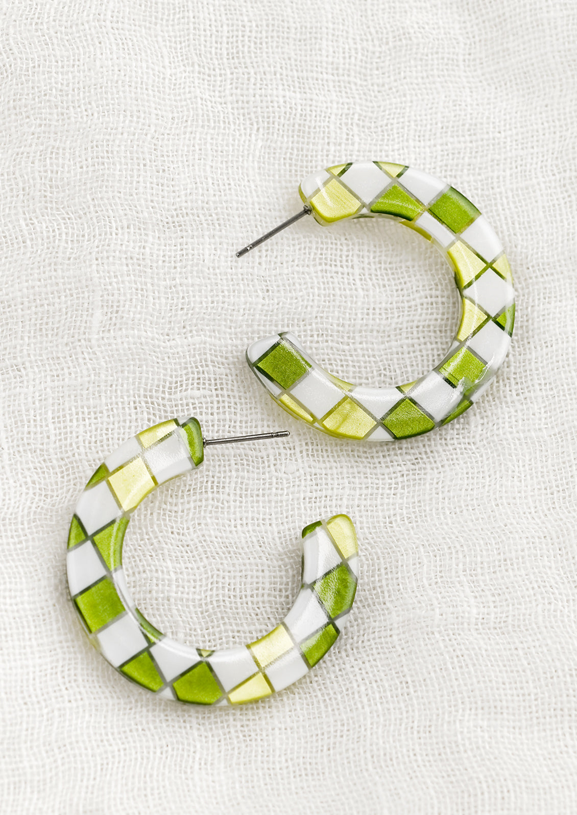 A pair of checkered earrings in green.