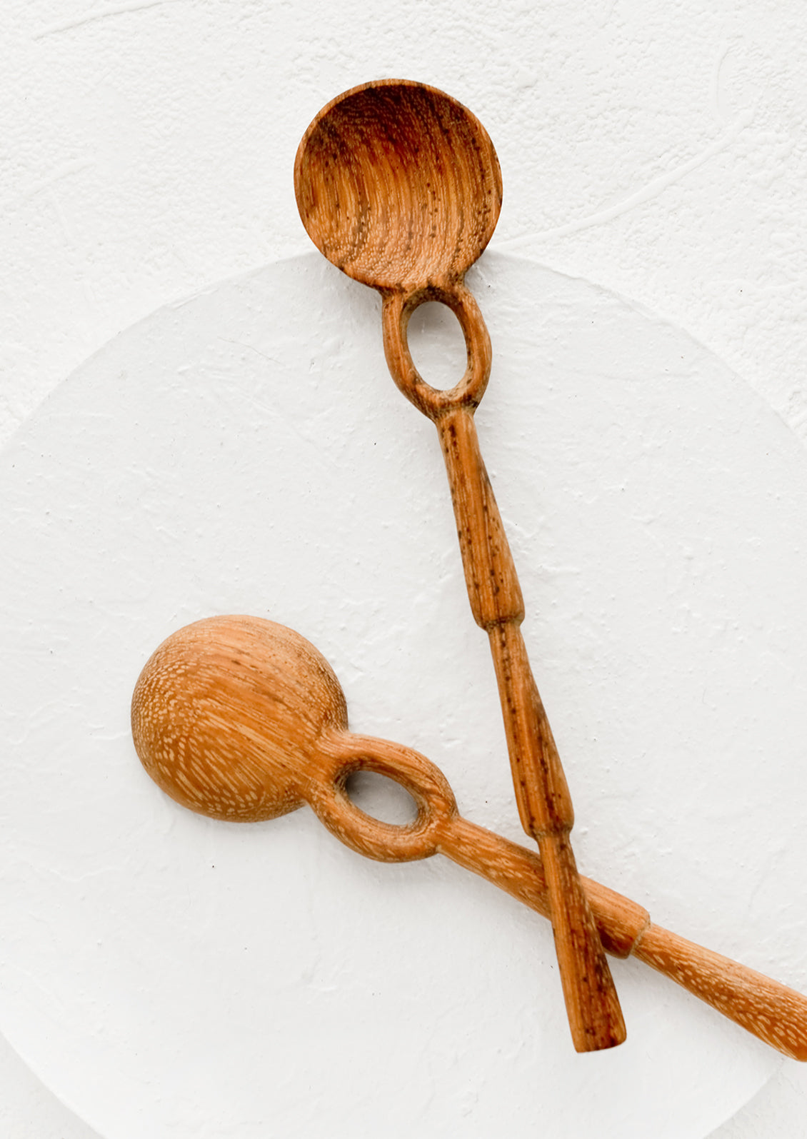 Two wooden spoons with unique shaker-inspired carved design.