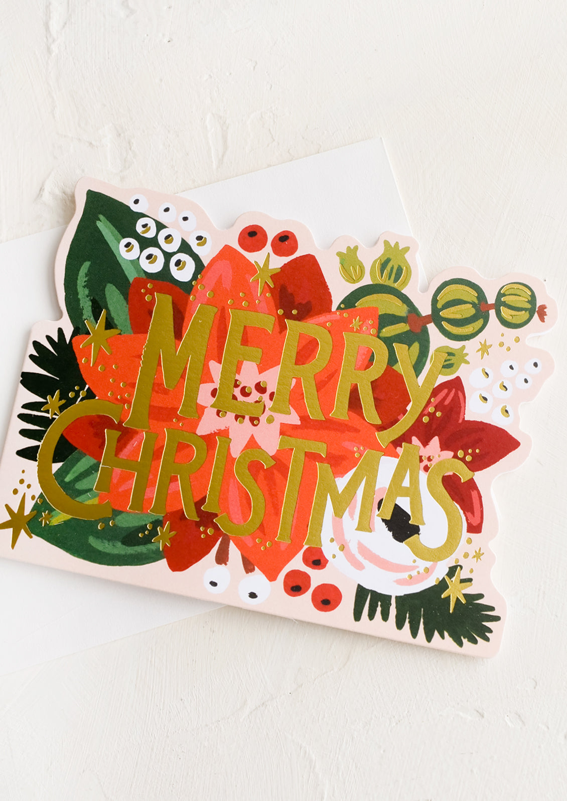 A diecut christmas card in poinsettia design.