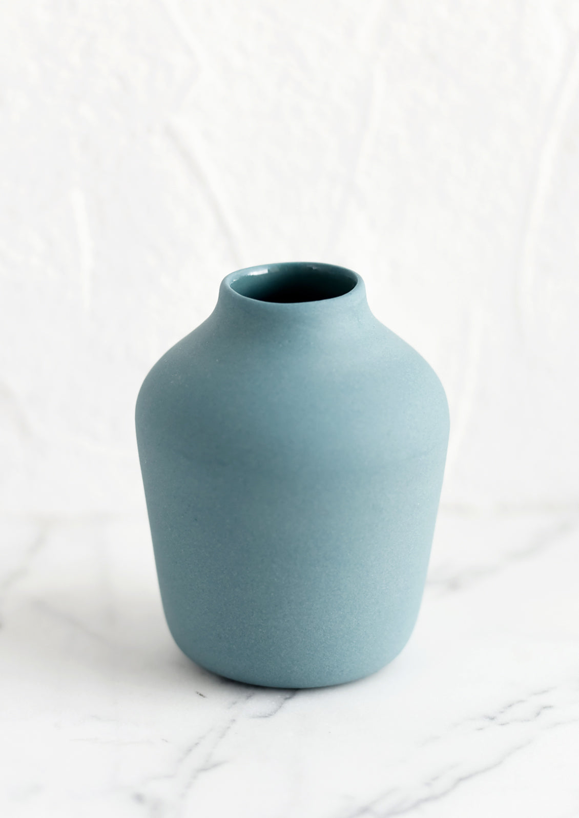 A mallard colored porcelain bud vase.