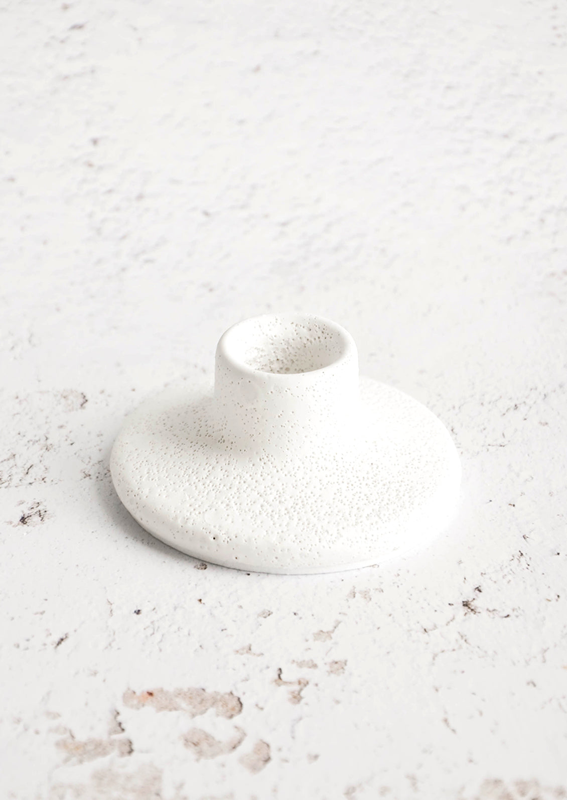 Short white ceramic taper holder in bubble-textured rough white glaze