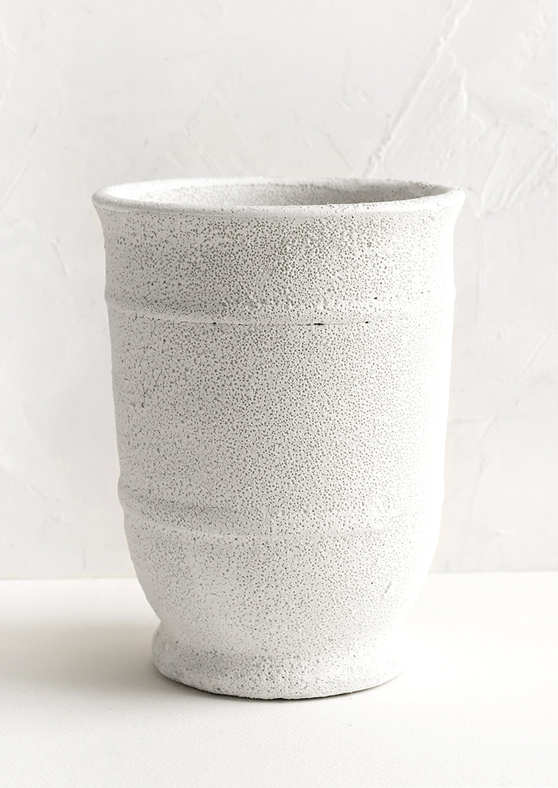 A tall planter in textured white glaze.