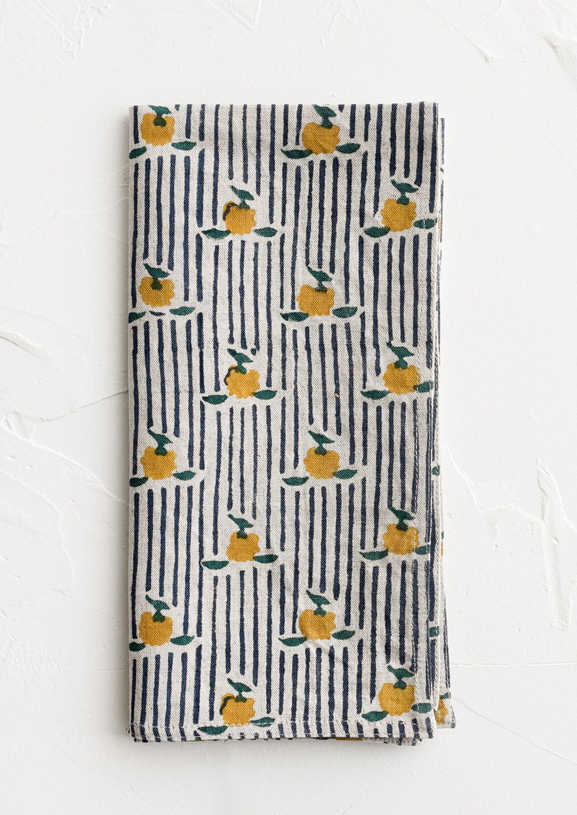 A block printed cotton napkin in stripe and floral pattern.