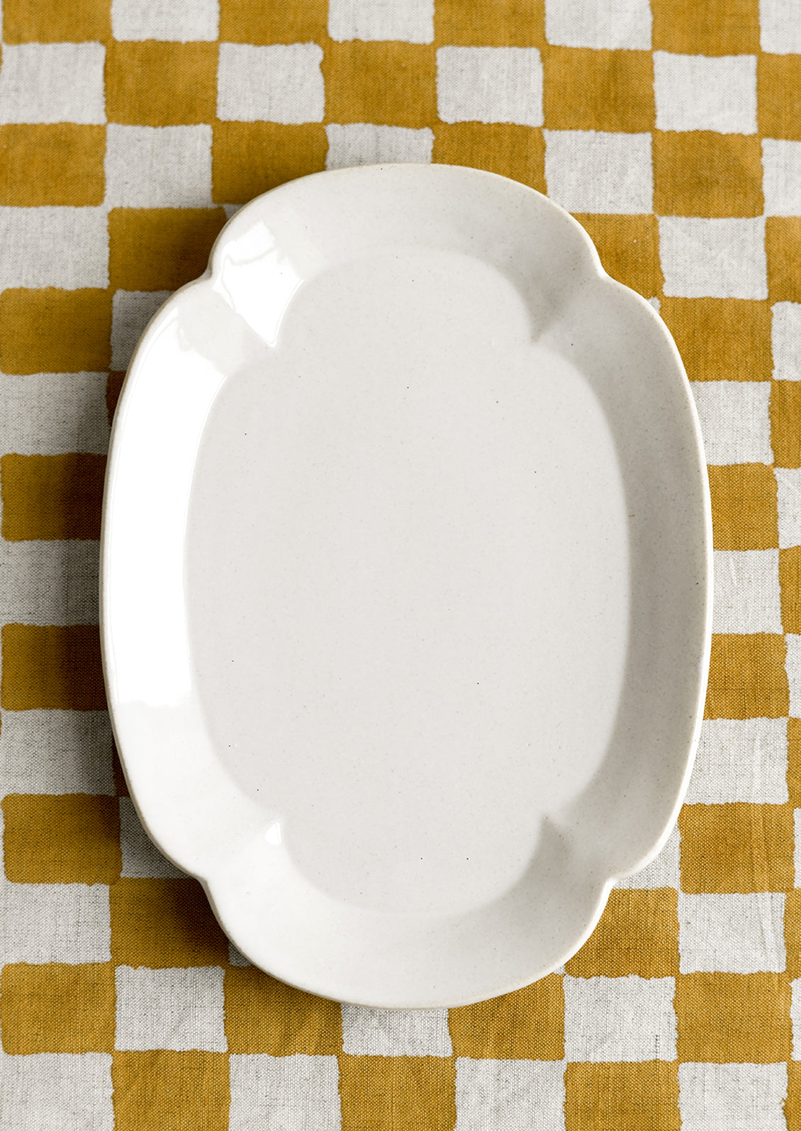 A quatrefoil shaped white ceramic platter/plate.