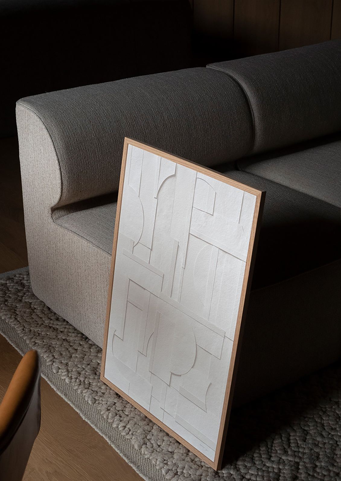 An art print featuring geometric cutout shapes of neutral paper, pieced together.