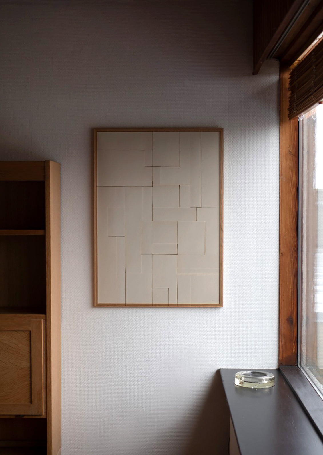 An art print featuring a photograph of layered neutral pieces of paper cut in squares and rectangles.