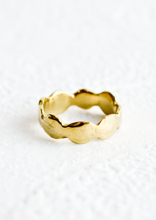 A brass ring in an organic, curvy shape.