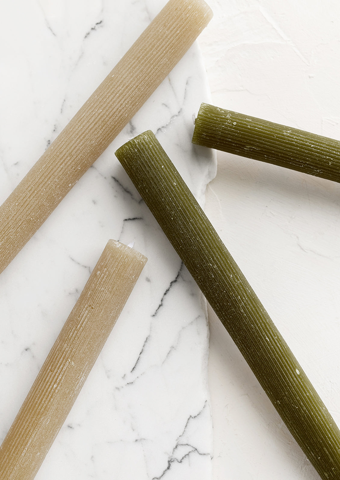 Taper candles with fine ribbed texture.