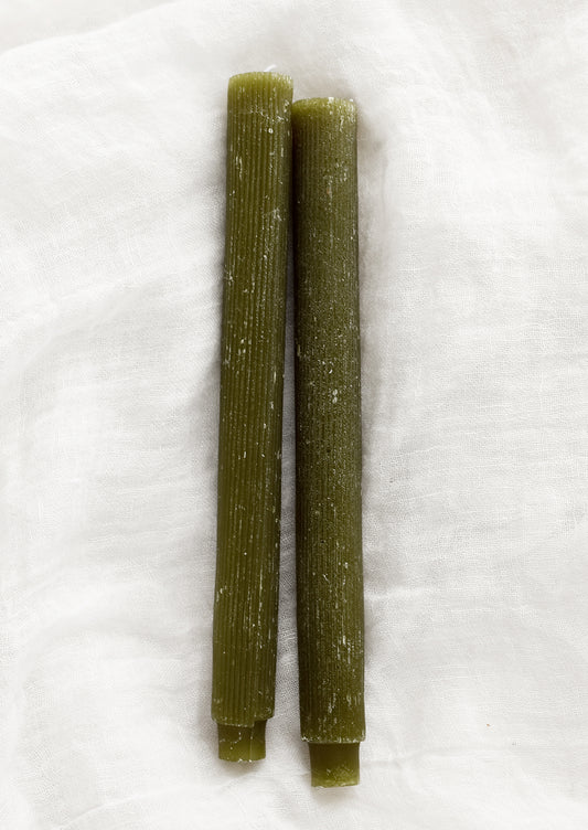 Taper candles with fine ribbed texture in moss green.