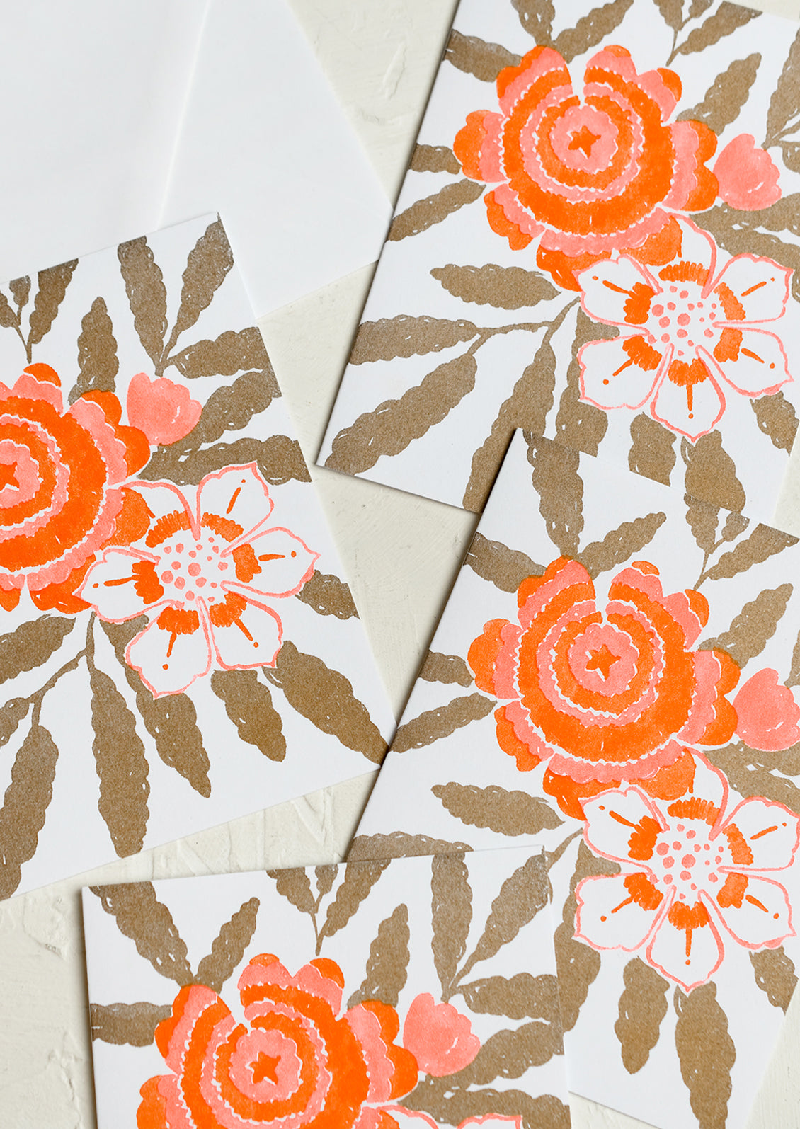 A floral print card set in gold and neon orange.