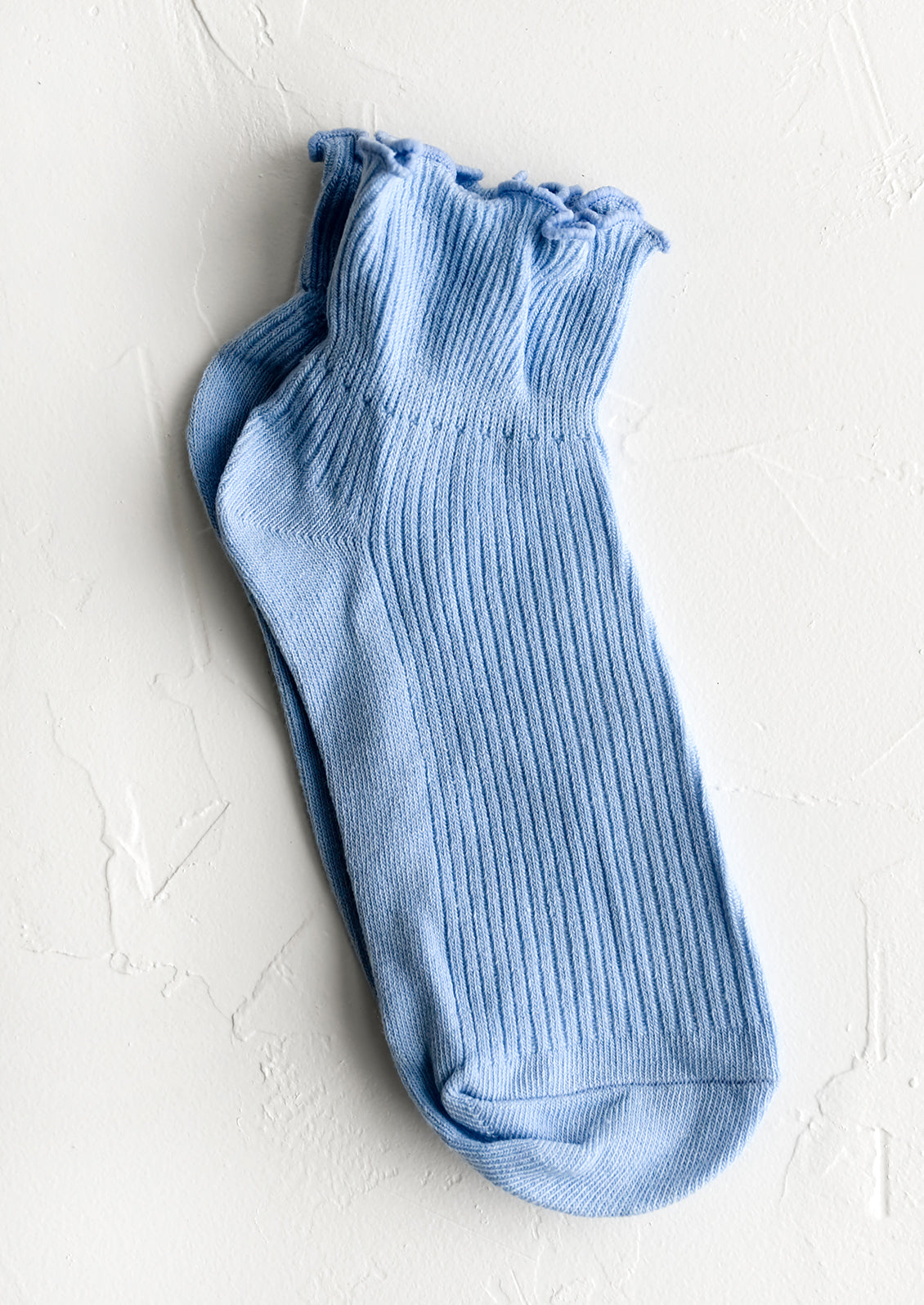 A pair of cotton ankle socks in sky blue.