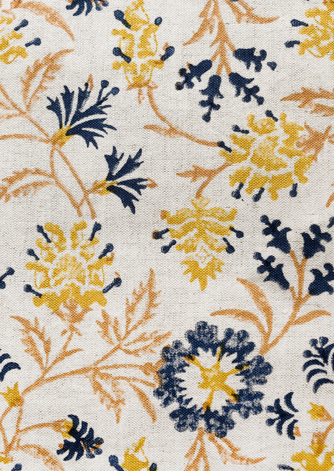 A block printed pillow in navy, brown and yellow floral print on natural linen.