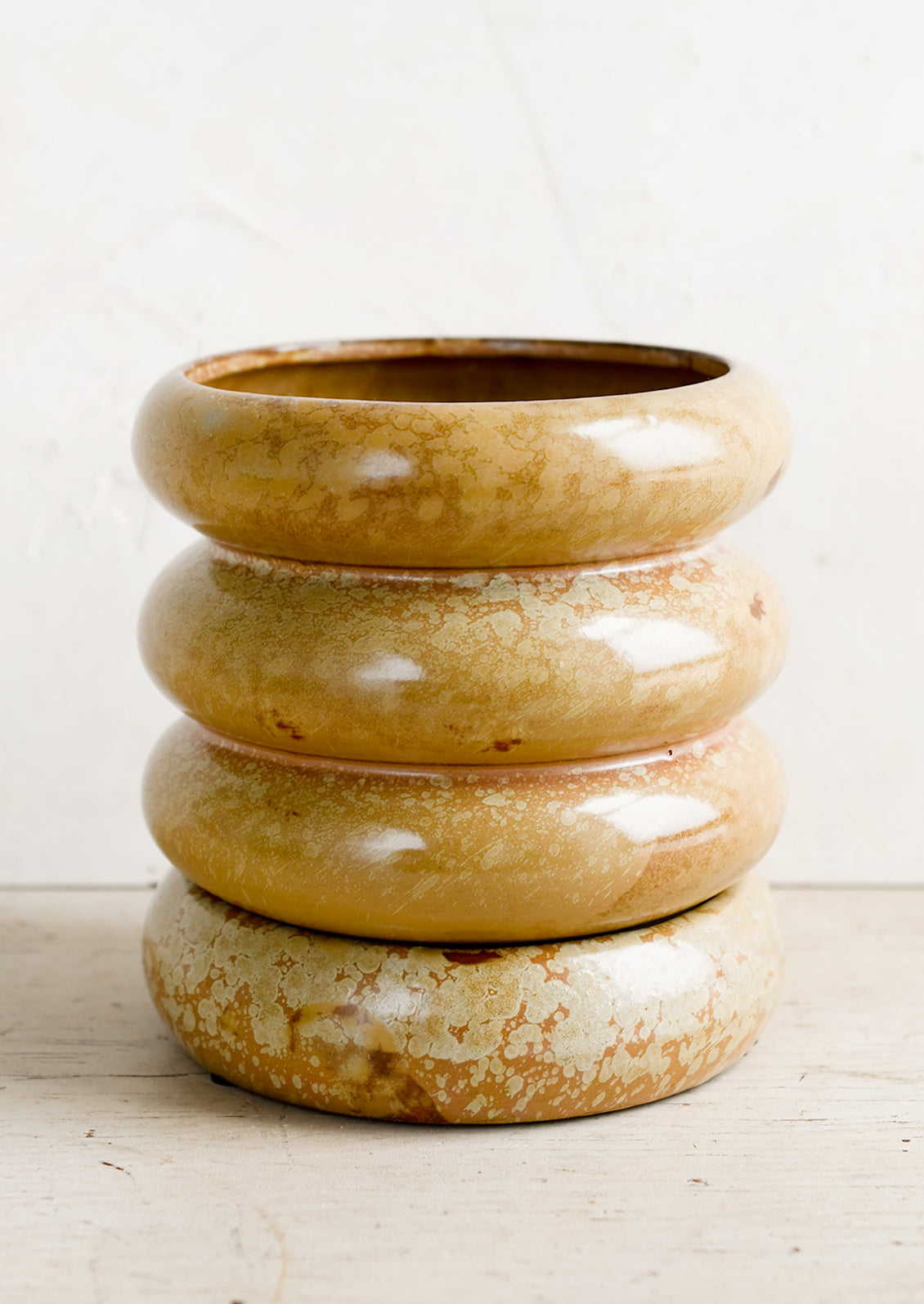 A curvy shaped planter in dappled brown glaze.