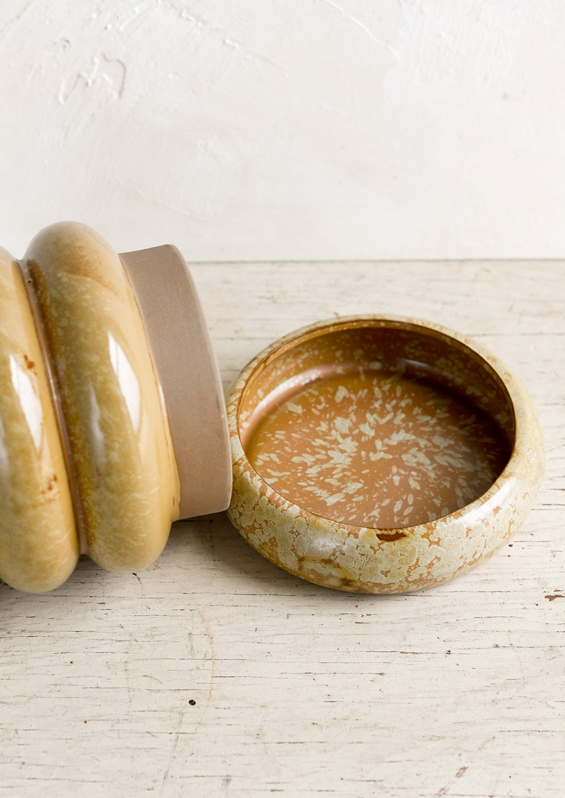 A ceramic planter with detachable base.